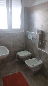 a bathroom with a toilet and a sink at Residence MARISOL in Cesenatico