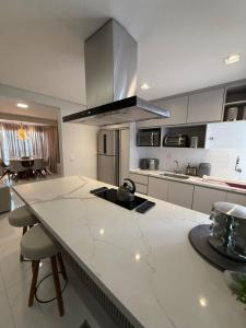 a kitchen with a large white counter top with a island at Charming Apartment in the Central Square in Bonito