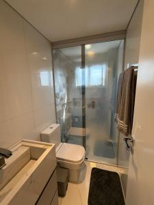 a bathroom with a toilet and a glass shower at Charming Apartment in the Central Square in Bonito