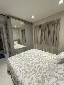 a bedroom with a large bed and a mirror at Charming Apartment in the Central Square in Bonito