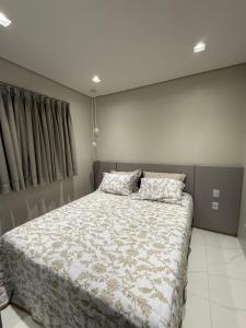 a bedroom with a bed with two pillows on it at Charming Apartment in the Central Square in Bonito +4 photos