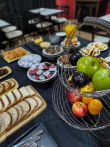 a table filled with different types of bread and fruit at Hotel Benevento in La Plata