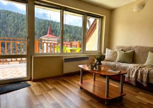 a living room with a couch and a table at Panoramic Cozy Apartment in Beli Iskar