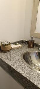 a bathroom counter with a sink and a mirror at Oasis Urbano Departamento Temporal in Santiago del Estero +15 photos