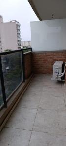 a balcony with a large window on a building at Oasis Urbano Departamento Temporal in Santiago del Estero