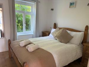 a bedroom with a bed with two towels on it at Seashells in Newquay
