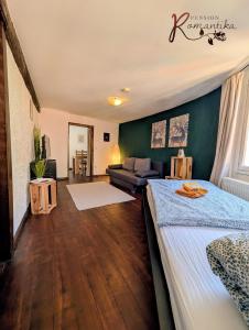 a living room with a bed and a couch at Gästehaus Pension Romantika in Cochem