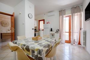 a dining room with a table and some chairs at Levante Eight Sea View Apartment in Bari