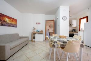a living room with a table and a couch at Levante Eight Sea View Apartment in Bari