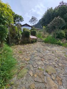 a stone path with a house in the background at Aguadulce Climbing House in Choachí