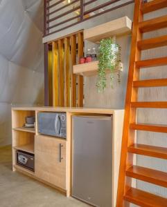 a living room with a tv and a staircase at Cardedeu Domos in Álvarez