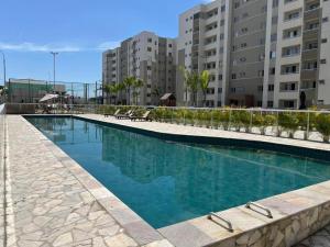 a large swimming pool in front of a building at 7 min de Cabo Frio AP LISBOA in São Pedro da Aldeia