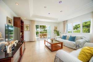a living room with a couch and a fish tank at Villa Sa Caleta de Cala D'or in Santanyi