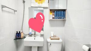 a bathroom with a heart sticker on the wall at 베델하우스 Bethel House in Seoul