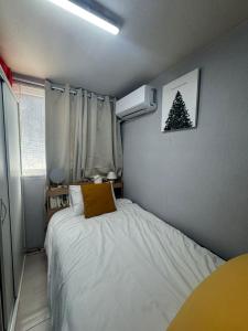 a small bedroom with a bed and a christmas tree on the wall at 베델하우스 Bethel House in Seoul