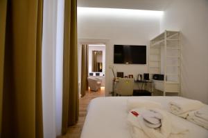 a bedroom with a bed with towels on it at Domus De Cinti Charme Rooms in Tivoli