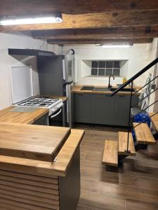 a kitchen with wooden tables and a stove top oven at Grange aménagée in Campan