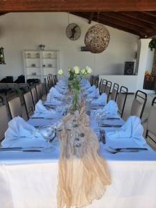 a long table with white plates and glasses on it at Zografia in Corfu +74 photos