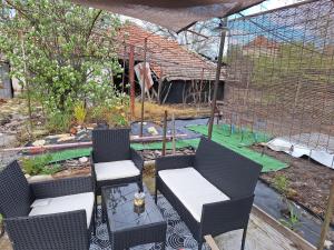 a patio with two chairs and a table in a garden at Cactus house in Ovchartsi