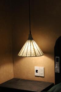 a light hanging from a wall next to a lightswitch at Tam Coc Thoms House in Ninh Binh
