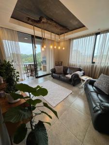 a living room with a couch and a table at The Concrete Edit in Benoni