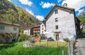 an old house in a village in the mountains at Vallemaggia Green House in Sornico