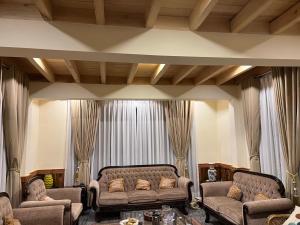 a living room with two couches and a table at Haven & Hearth in Hunza Valley