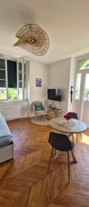 a living room with a couch and a table at Chez Nous in Saint-Paul-lès-Dax
