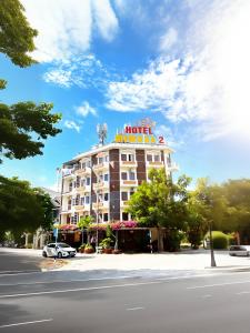 a hotel building with a sign on top of it at Mimosa 2 Hotel - Phan Rang in Phan Rang–Tháp Chàm