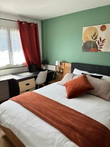 a bedroom with a bed with a desk and a red curtain at LA Petite ferme 1 in Saint-Maur-des-Fossés
