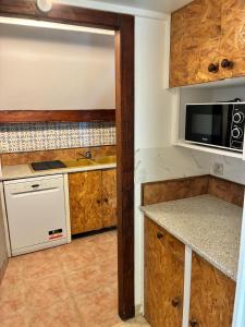 a small kitchen with a sink and a microwave at LA Petite ferme 1 in Saint-Maur-des-Fossés