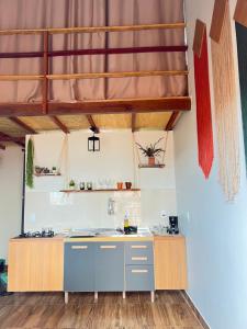 a kitchen with a sink and a wooden ceiling at Apt estiloso 01 in Paragominas +6 photos