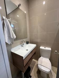 a bathroom with a sink and a toilet and a mirror at Studio Matriz 1 e 2 in São Sebastião +37 photos