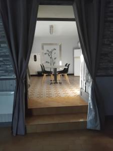 a dining room with a table and chairs at Déconnection in Saint-Cyr-des-Gâts
