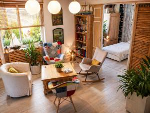 a living room with chairs and a table at Un coin de paradis in Oullins +14 photos