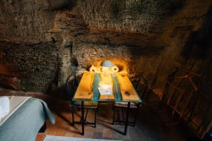 a table in a cave with a lamp on it at La Voûte Etoilée in Doué-la-Fontaine
