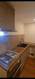 a kitchen with a stove top oven next to a sink at Cabañas Bio Bio Osorno in Osorno +4 photos