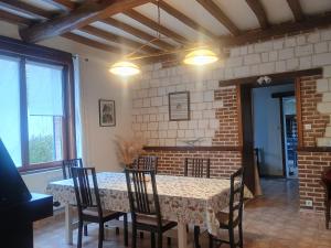 a dining room with a table and chairs at demeure à la campagne in Conchy-sur-Canche