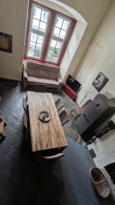 a living room with a wooden table and a couch at Altstadthaus in Arnsberg