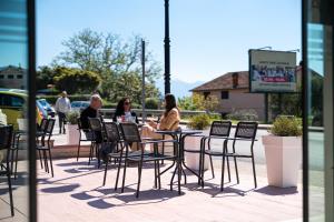 a group of people sitting at a table at Castello Mare Residence in Herceg-Novi