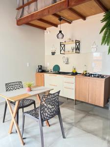a kitchen with a table and two chairs and a table at Apt estiloso 02 in Paragominas +4 photos