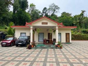 a house with a car parked in front of it at Belandoor Nature Nest in Sringeri