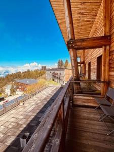 a view from the balcony of a log cabin at studio Nivéole 303 in Chamrousse