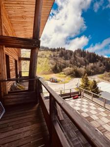 a balcony with a view of a parking lot at studio Nivéole 303 in Chamrousse +4 photos