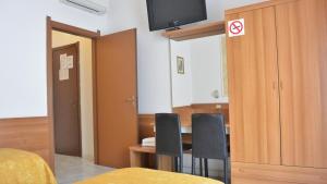 Televízia a/alebo spoločenská miestnosť v ubytovaní Hotel Mignon
