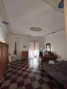a bedroom with a bed and a checkered floor at Dimora di Diamante in Diamante +75 photos