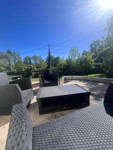 a patio with a table and chairs and the sun at Déconnection in Saint-Cyr-des-Gâts