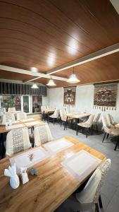 a dining room with wooden tables and chairs at Eco House in Osh