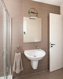a bathroom with a sink and a mirror at Calypso 3 Large Stylish Apartment in Paceville with Mercury Tower View Ideal for Groups in St. Julianʼs