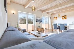 a living room with a couch and a table at Ferienhaus Basstölpel in Dagebüll